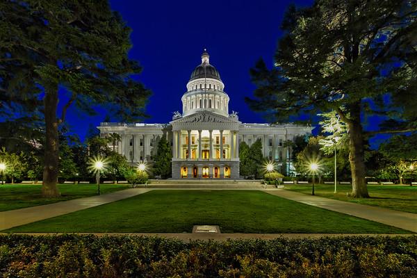 California State Capitol at night with columns and dome illuminated