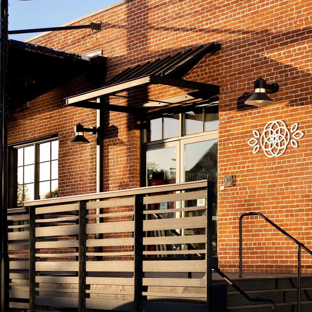 Camellia Coffee Roasters brick exterior with wooden deck and logo